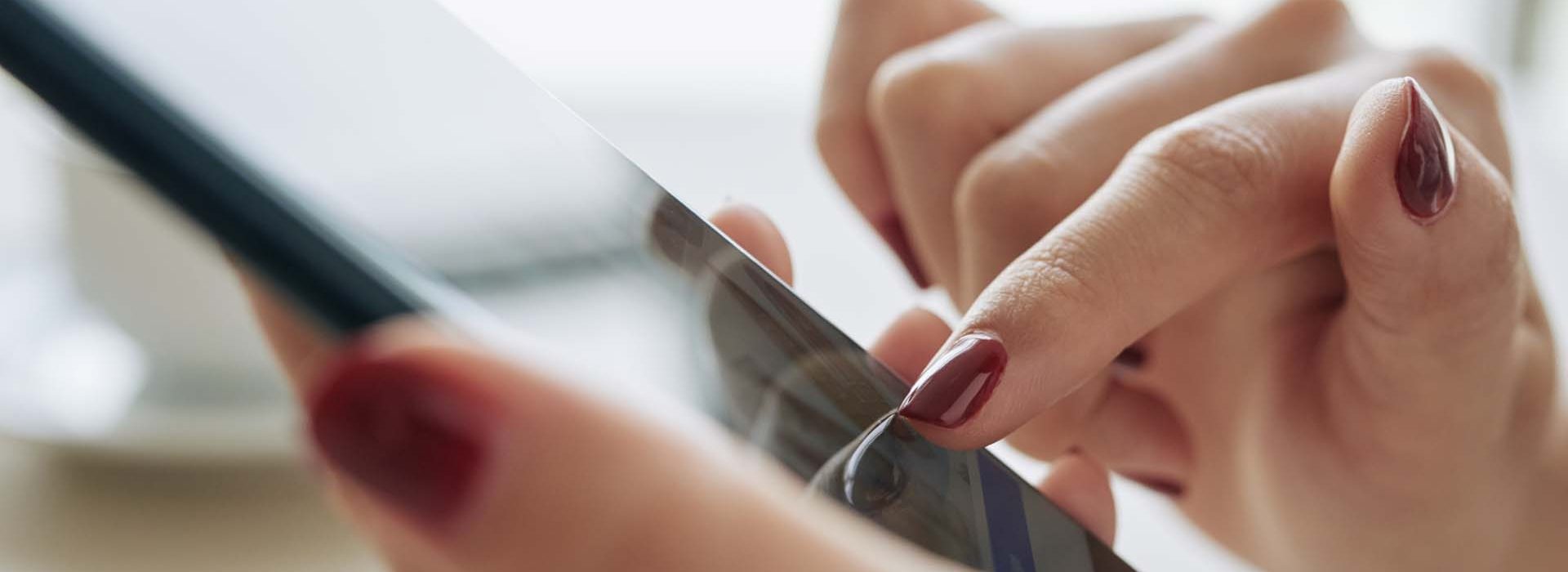 Close-up image of woman using application on smartphone