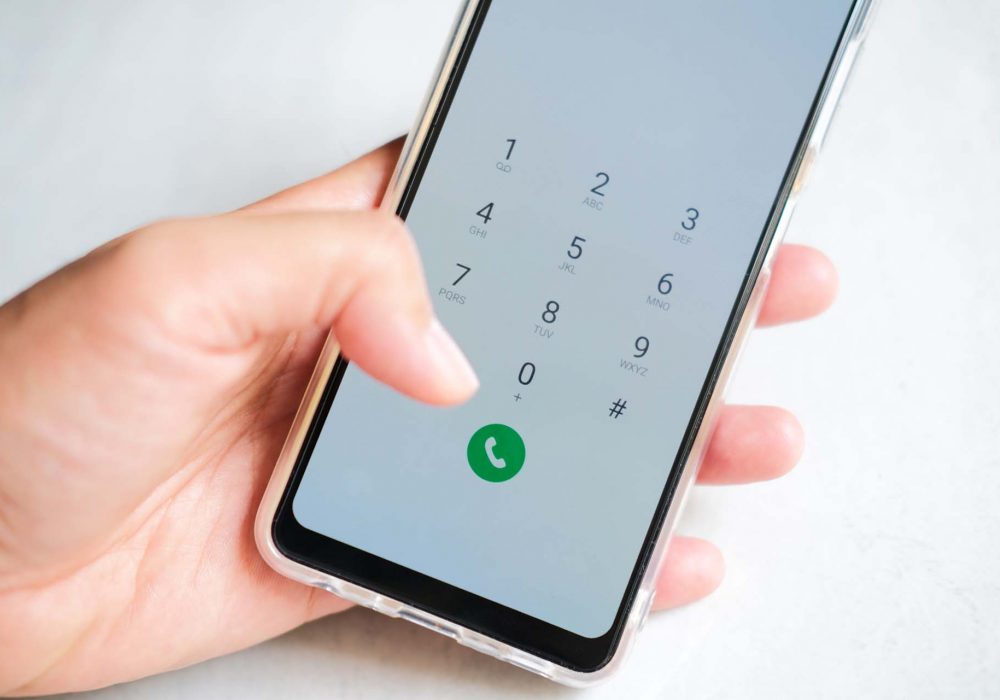 Person hand holding mobile phone and pressing call button